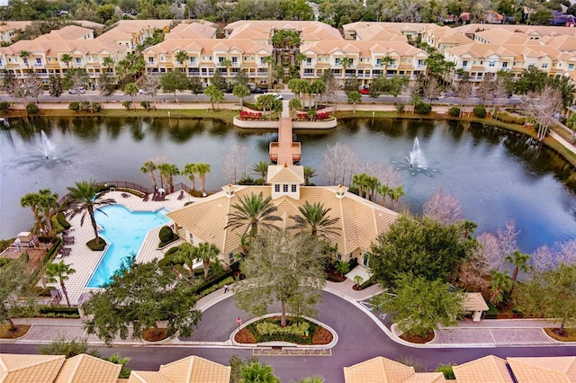 aerial view of residential area with a large body of water and a pool