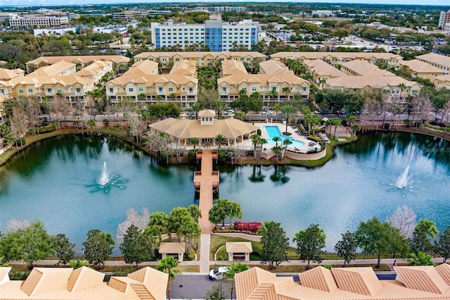 drone / aerial view of a nearby body of water and a pool area