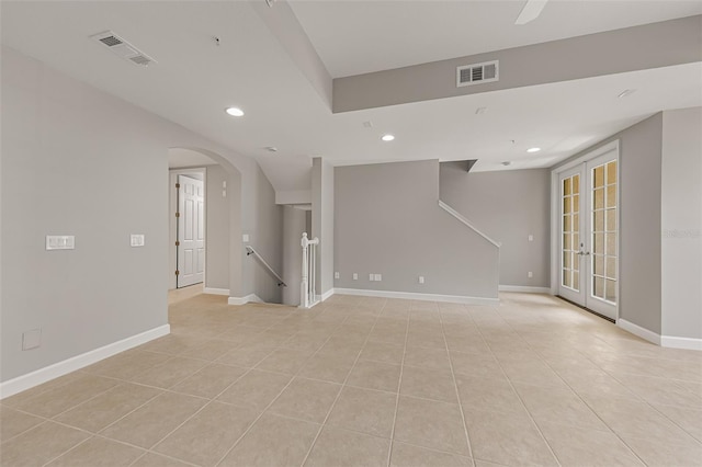 unfurnished room with recessed lighting, light tile patterned floors, arched walkways, and baseboards