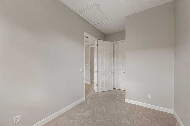 carpeted spare room featuring baseboards