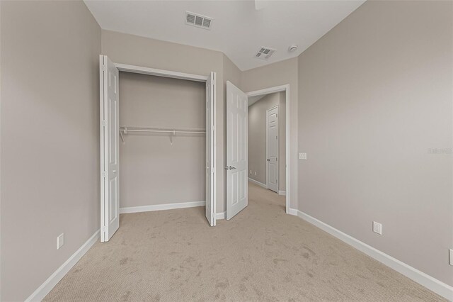 unfurnished bedroom featuring carpet, a closet, and baseboards