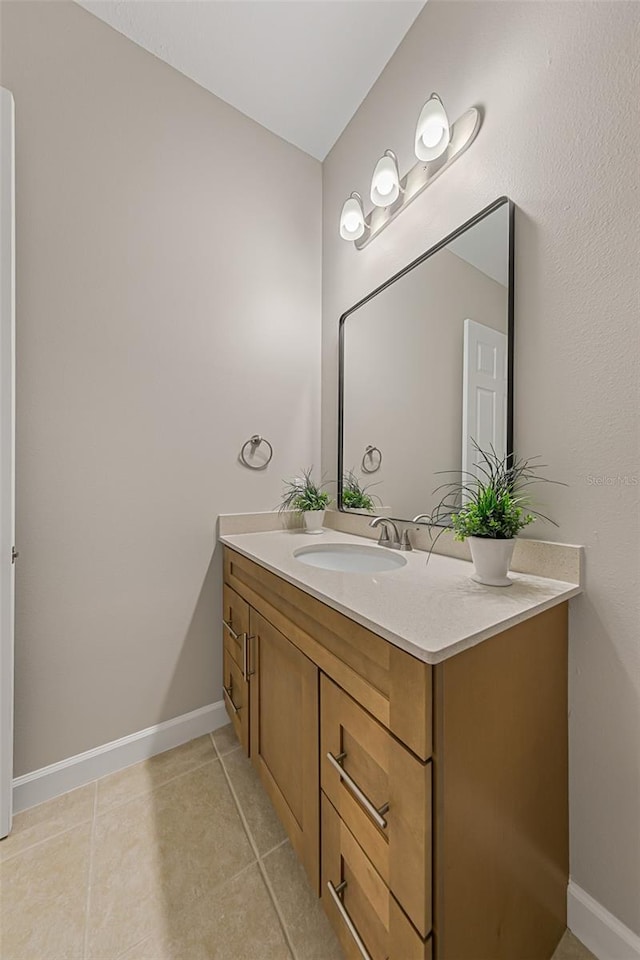 bathroom with vanity, tile patterned floors, and baseboards