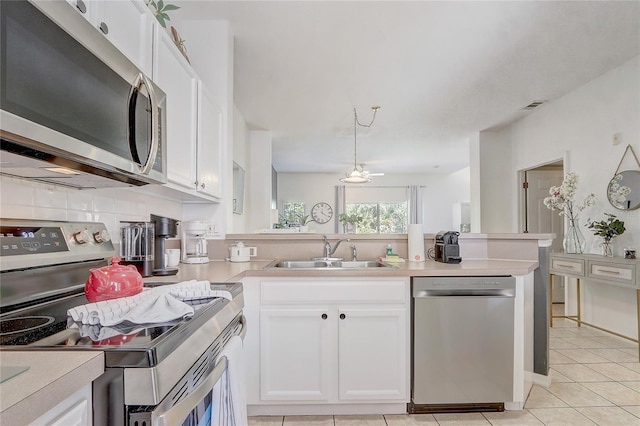 1041 Park Ridge Cir, Kissimmee, FL 34746 - kitchen featuring a sink, white cabinetry, appliances with stainless steel finishes, and light countertops