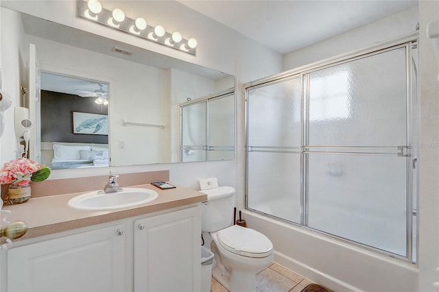 1041 Park Ridge Cir, Kissimmee, FL 34746 - full bath featuring visible vents, vanity, tile patterned floors, combined bath / shower with glass door, and toilet