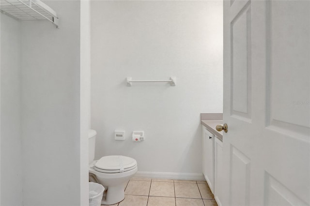1041 Park Ridge Cir, Kissimmee, FL 34746 - half bath featuring tile patterned floors, baseboards, vanity, and toilet