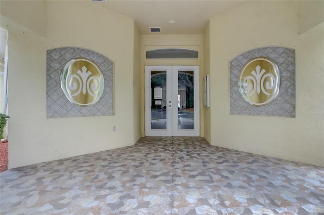 1041 Park Ridge Cir, Kissimmee, FL 34746 - doorway to property featuring stucco siding, french doors, and visible vents