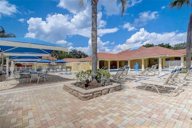 1041 Park Ridge Cir, Kissimmee, FL 34746 - community pool featuring a patio and fence