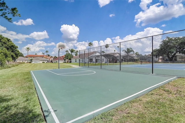 1041 Park Ridge Cir, Kissimmee, FL 34746 - view of basketball court with fence, community basketball court, a yard, and a residential view