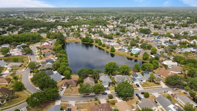 aerial view of property's location featuring a nearby body of water and nearby suburban area