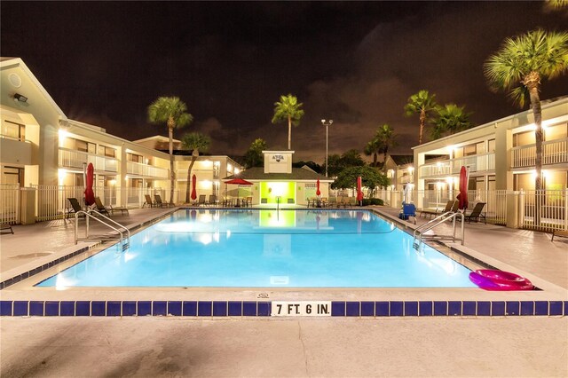 5245 W Irlo Bronson Memorial Hwy Unit 151, Kissimmee, FL 34746 - pool at twilight featuring fence, a community pool, and a patio
