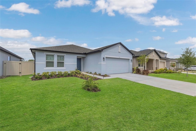 1312 Axel Graeson Ave, Kissimmee, FL 34744 - ranch-style home featuring a front lawn, stucco siding, a gate, an attached garage, and driveway
