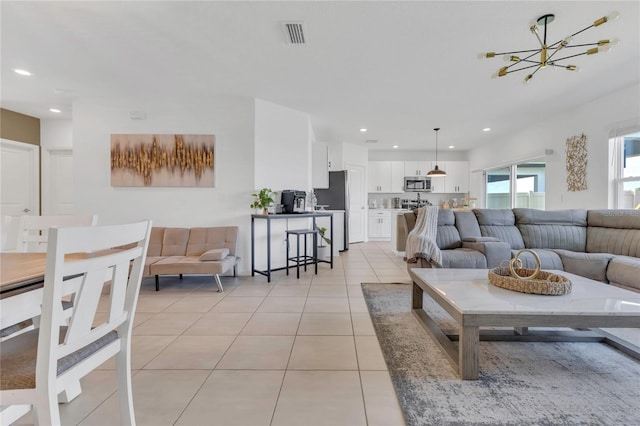 1312 Axel Graeson Ave, Kissimmee, FL 34744 - living area featuring light tile patterned floors, visible vents, recessed lighting, and a chandelier