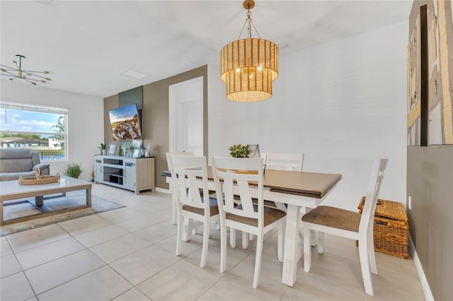 1312 Axel Graeson Ave, Kissimmee, FL 34744 - dining area featuring baseboards, a chandelier, and light tile patterned floors