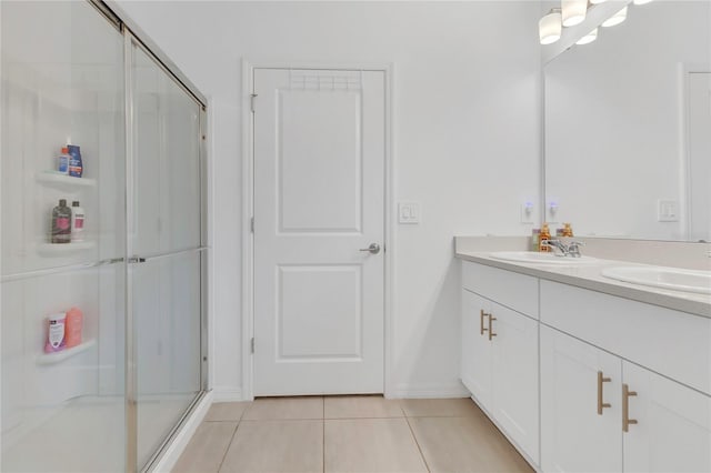 1312 Axel Graeson Ave, Kissimmee, FL 34744 - bathroom with double vanity, a sink, tile patterned flooring, and a stall shower