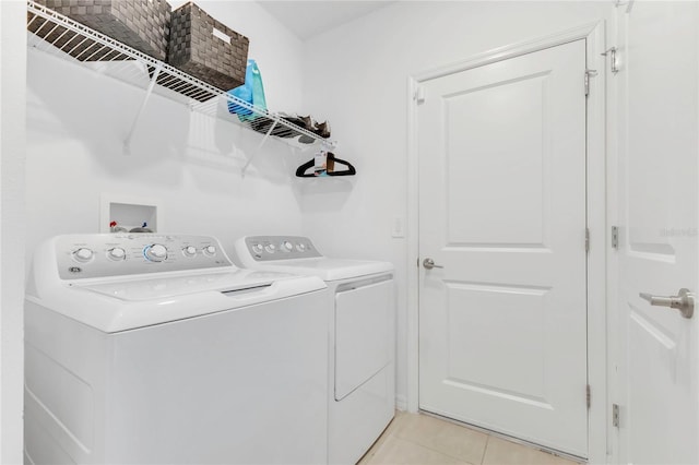 1312 Axel Graeson Ave, Kissimmee, FL 34744 - laundry room featuring washer and dryer, laundry area, and light tile patterned floors