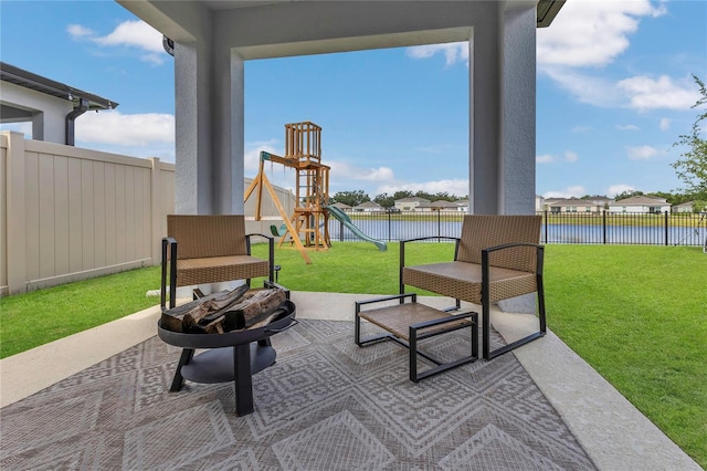 1312 Axel Graeson Ave, Kissimmee, FL 34744 - view of patio with a fenced backyard, a water view, and an outdoor fire pit