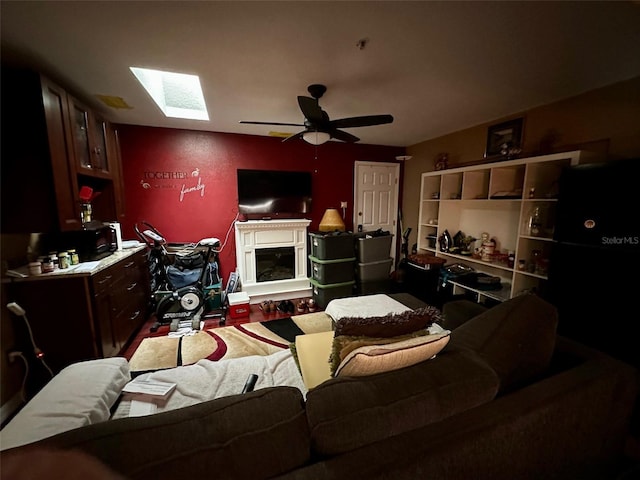 300 Broadview Ave, Altamonte Springs, FL 32701 - living room featuring a ceiling fan, a skylight, and a glass covered fireplace