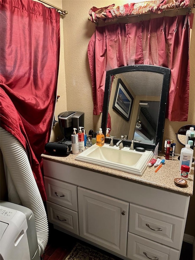 300 Broadview Ave, Altamonte Springs, FL 32701 - bathroom featuring wood finished floors, vanity, and a textured wall
