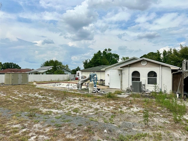 300 Broadview Ave, Altamonte Springs, FL 32701 - back of property featuring central AC unit, a storage shed, fence, and an outbuilding