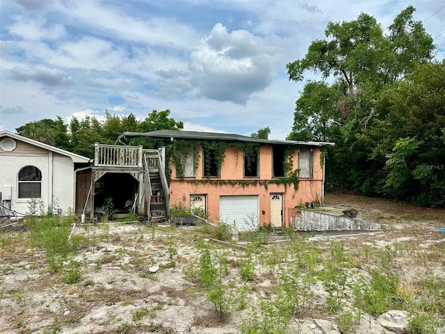 300 Broadview Ave, Altamonte Springs, FL 32701 - view of front of property featuring stairs, a wooden deck, a garage, and stucco siding
