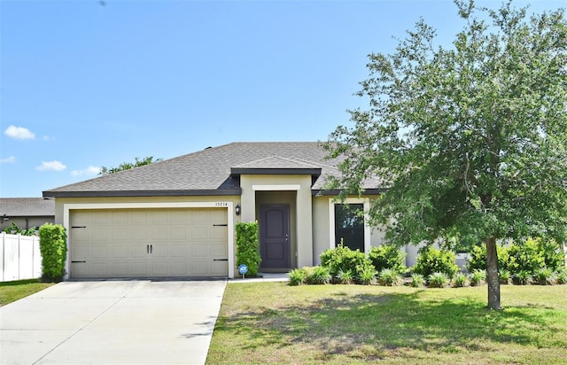35734 Rose Moss Ave, Leesburg, FL 34788 - view of front facade featuring an attached garage, stucco siding, driveway, and a front yard