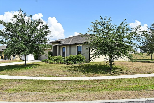 35734 Rose Moss Ave, Leesburg, FL 34788 - view of front of house with a garage, roof with shingles, stucco siding, and a front yard