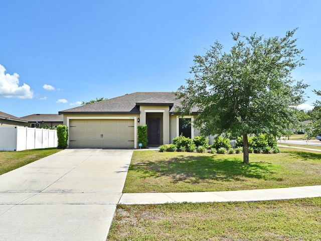 35734 Rose Moss Ave, Leesburg, FL 34788 - view of front of home with fence, a garage, driveway, and stucco siding
