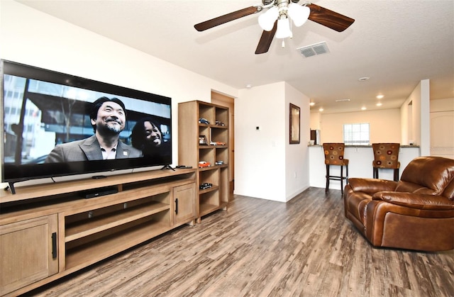35734 Rose Moss Ave, Leesburg, FL 34788 - living room featuring visible vents, ceiling fan, and wood finished floors
