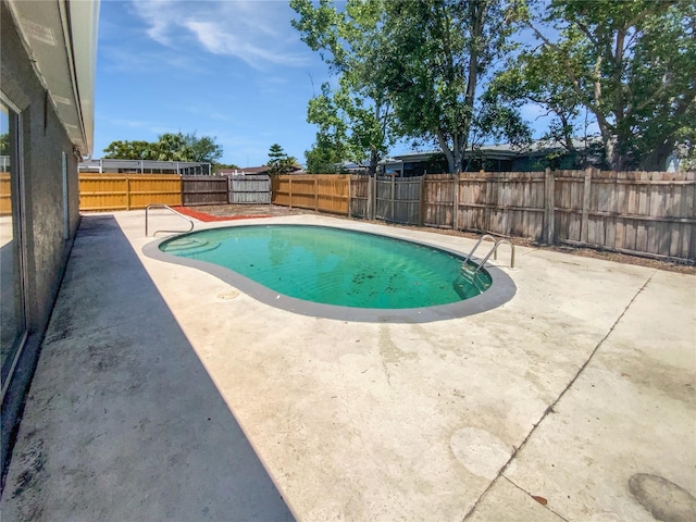 view of pool featuring a fenced in pool, a fenced backyard, and a patio area