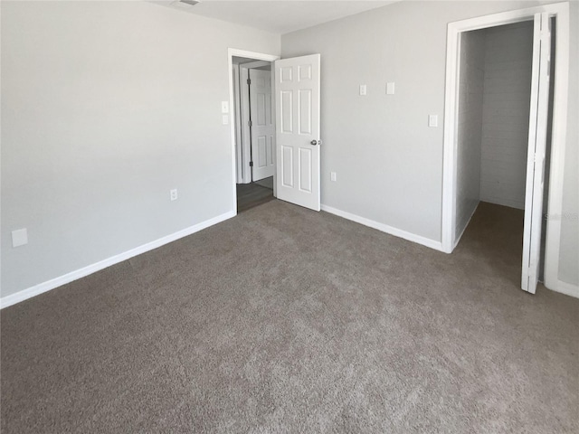 unfurnished bedroom with carpet floors and baseboards
