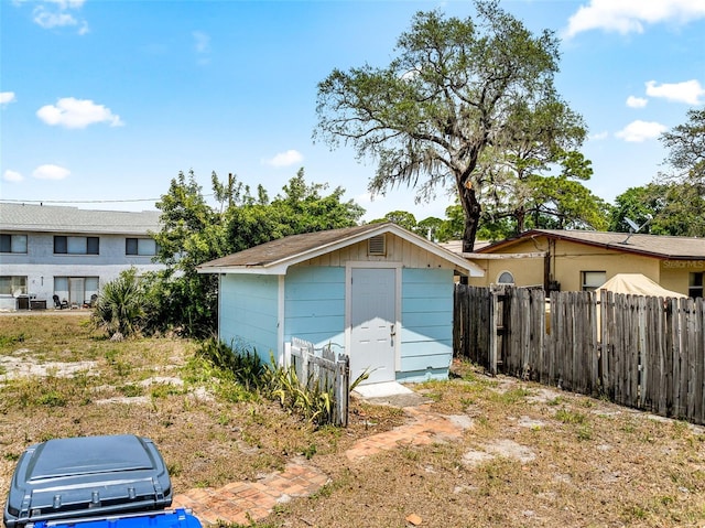 garage with a shed and fence