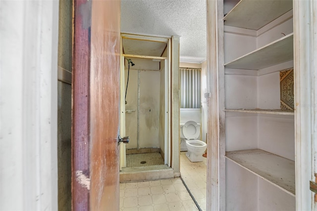 full bath featuring tile patterned floors, a shower stall, and toilet