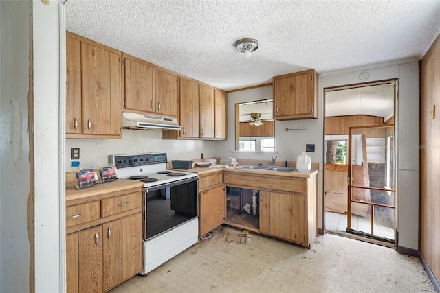 kitchen with a sink, a textured ceiling, light floors, under cabinet range hood, and white electric stove