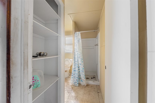 full bath with tile patterned flooring, a stall shower, and toilet