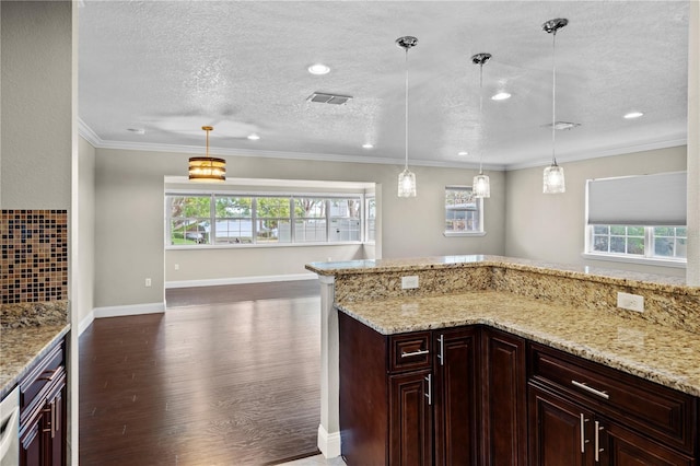 101 E Lauren Ct, Fern Park, FL 32730 - kitchen featuring dark wood finished floors, light stone counters, pendant lighting, a textured ceiling, and recessed lighting