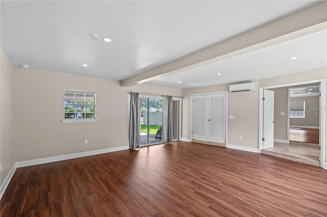 101 E Lauren Ct, Fern Park, FL 32730 - unfurnished bedroom with a wall mounted air conditioner, baseboards, wood finished floors, access to exterior, and beam ceiling