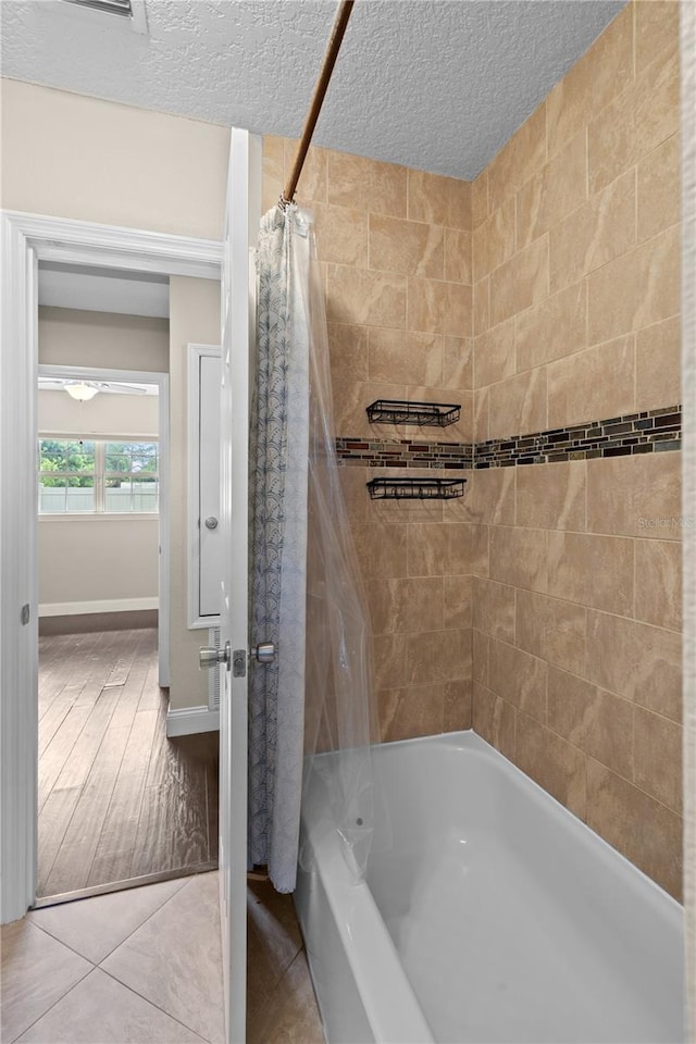 101 E Lauren Ct, Fern Park, FL 32730 - bathroom featuring shower / bath combo, a textured ceiling, and tile patterned flooring