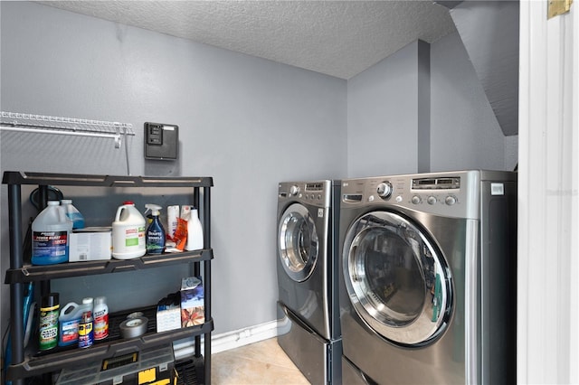 101 E Lauren Ct, Fern Park, FL 32730 - clothes washing area with washing machine and dryer, baseboards, a textured ceiling, and tile patterned flooring