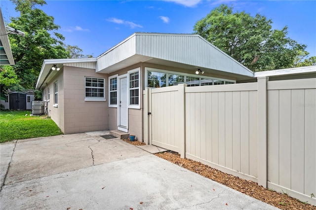101 E Lauren Ct, Fern Park, FL 32730 - back of property with a shed, fence, central air condition unit, a patio, and concrete block siding