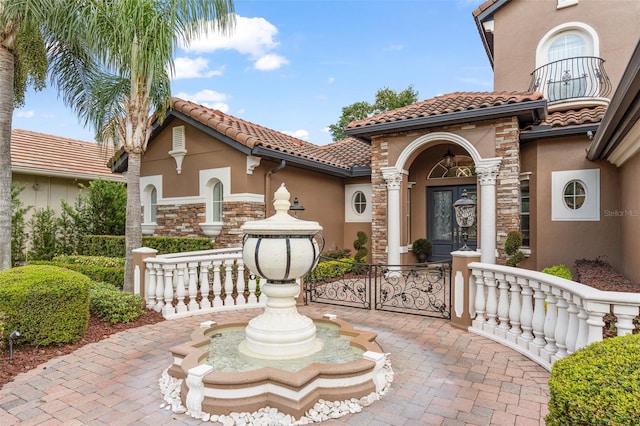 1450 Belfiore Way, Windermere, FL 34786 - doorway to property with stucco siding and a tiled roof