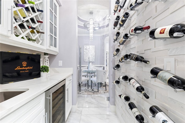 1450 Belfiore Way, Windermere, FL 34786 - wine room with beverage cooler, light marble finish floors, and ornamental molding