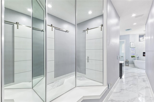 1450 Belfiore Way, Windermere, FL 34786 - bathroom featuring marble finish floors, a freestanding bath, vanity, a shower with door, and recessed lighting