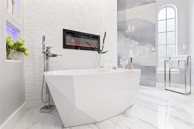 1450 Belfiore Way, Windermere, FL 34786 - bathroom featuring marble tiled flooring, a freestanding tub, and a glass covered fireplace