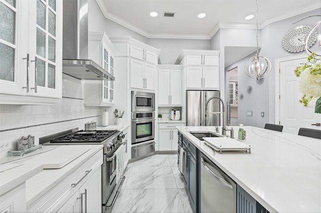 1450 Belfiore Way, Windermere, FL 34786 - kitchen with stainless steel appliances, wall chimney range hood, white cabinetry, a chandelier, and a warming drawer