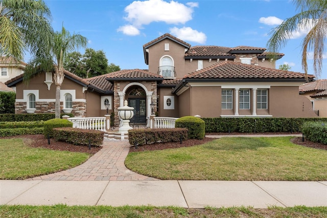 1450 Belfiore Way, Windermere, FL 34786 - mediterranean / spanish-style house with stucco siding, a front lawn, and a tiled roof
