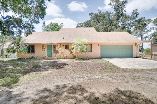 ranch-style home featuring a garage and driveway