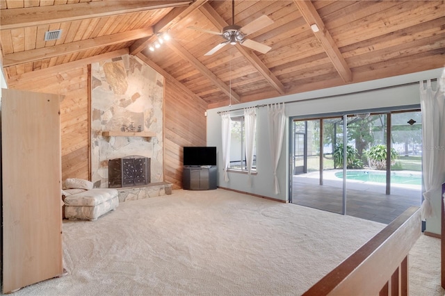 unfurnished living room with carpet flooring, wood walls, a ceiling fan, visible vents, and wood ceiling