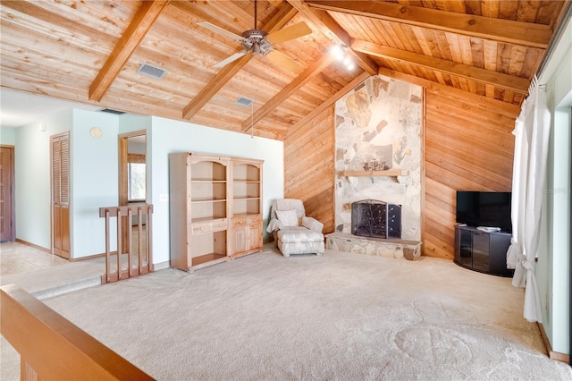 interior space with carpet flooring, wooden walls, a large fireplace, wooden ceiling, and vaulted ceiling with beams