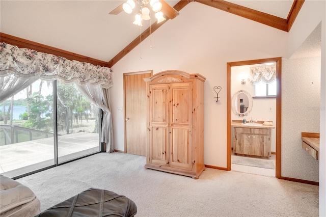 unfurnished living room featuring a sink, high vaulted ceiling, carpet flooring, and a healthy amount of sunlight