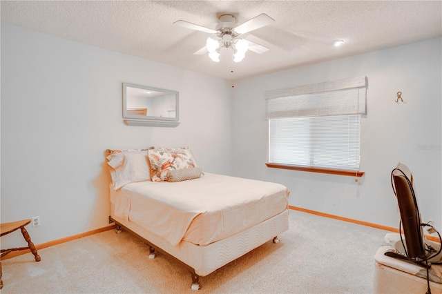bedroom with carpet floors, a textured ceiling, and baseboards